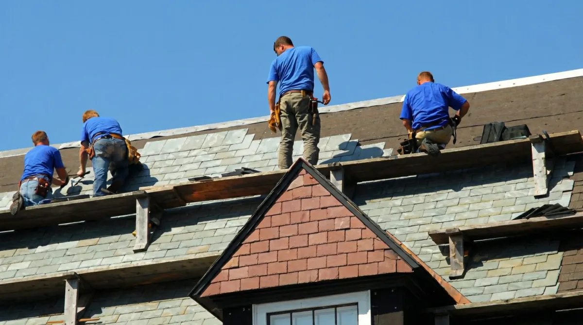 Roof replacement in progress with a team of professional contractors installing new shingles on a residential home in Marietta, GA